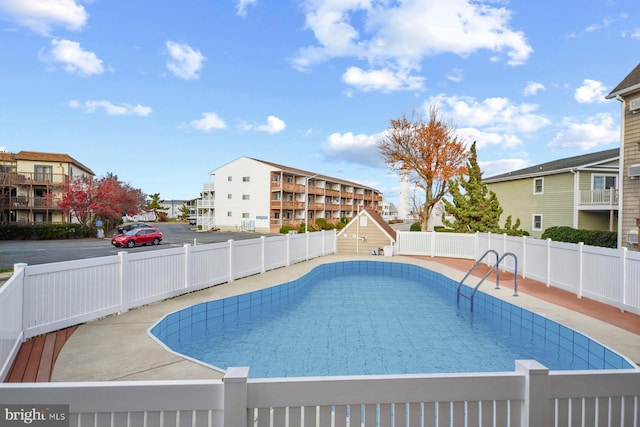 view of swimming pool featuring a patio area, a fenced backyard, and a fenced in pool