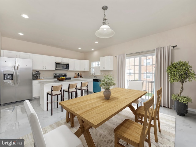 dining area featuring recessed lighting and marble finish floor