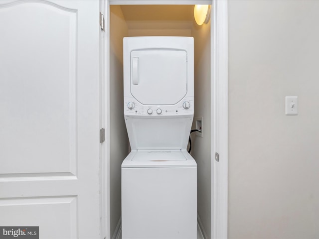 laundry room featuring laundry area and stacked washer / drying machine