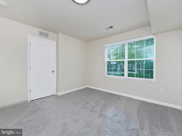 empty room with light carpet, baseboards, and visible vents