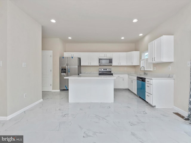 kitchen featuring a center island, marble finish floor, light countertops, appliances with stainless steel finishes, and white cabinets