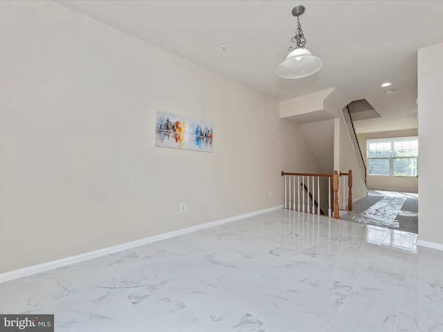 spare room featuring marble finish floor, recessed lighting, and baseboards