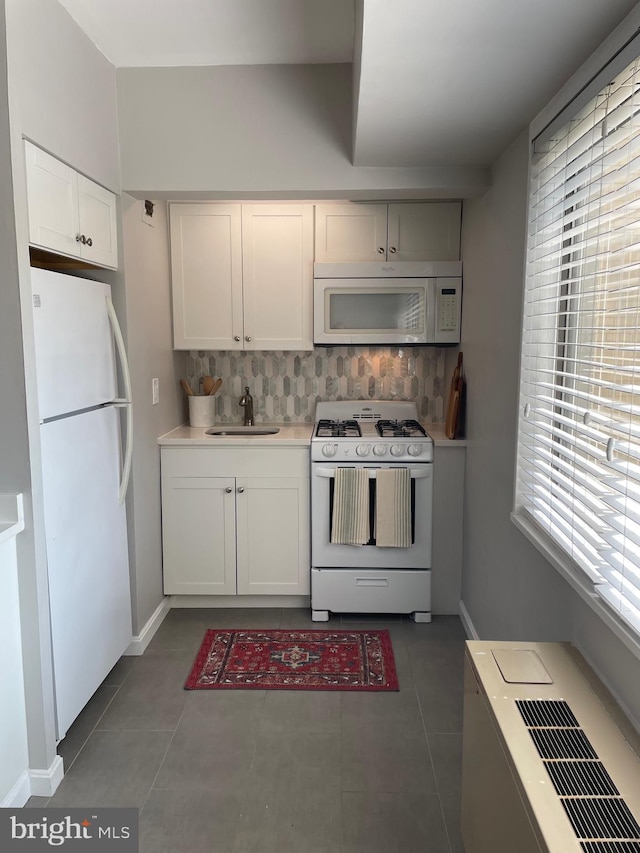 3701 Connecticut Ave NW Unit 311, Washington, DC 20008 - kitchen featuring white appliances, a sink, tasteful backsplash, light countertops, and dark tile patterned flooring