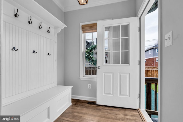 mudroom with baseboards, ornamental molding, and dark wood-style flooring