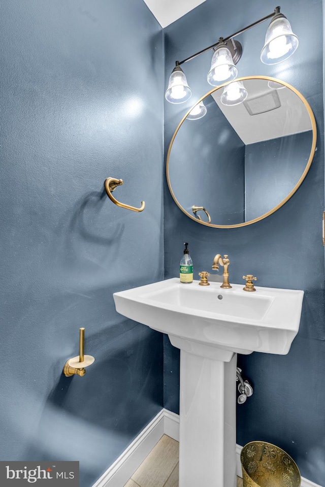 bathroom featuring baseboards and wood finished floors