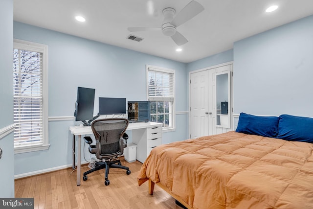 bedroom featuring visible vents, multiple windows, hardwood / wood-style flooring, and recessed lighting