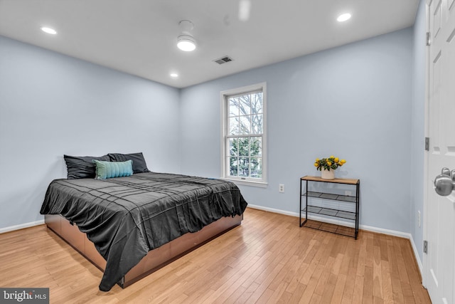 bedroom with recessed lighting, visible vents, baseboards, and wood finished floors