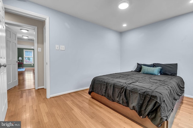 bedroom featuring recessed lighting, light wood-style flooring, and baseboards