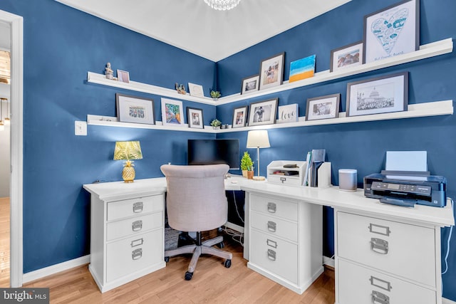 office area with light wood-style floors and baseboards