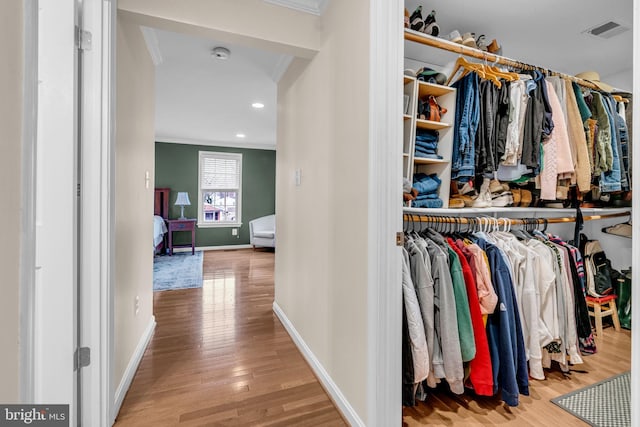 spacious closet with visible vents and wood finished floors