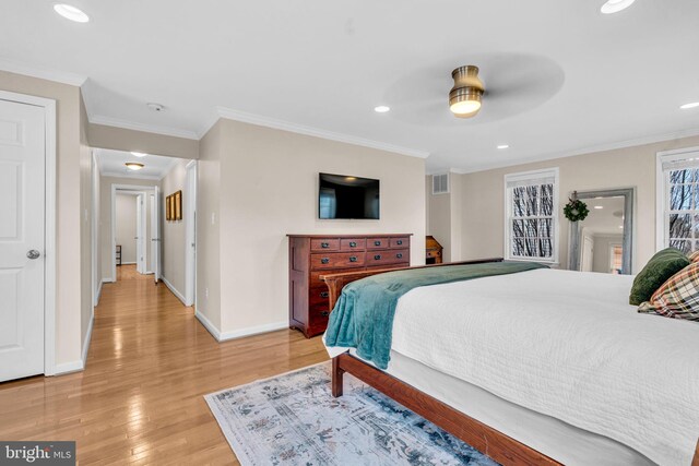 bedroom with light wood finished floors, baseboards, and ornamental molding