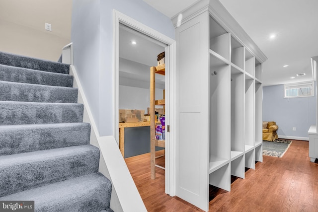 interior space featuring baseboards, wood finished floors, and recessed lighting