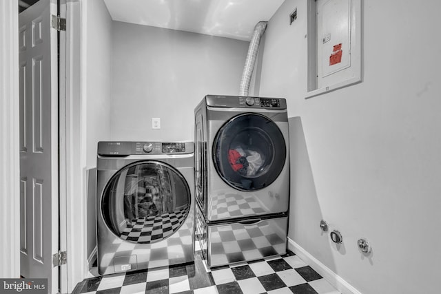 clothes washing area featuring laundry area, electric panel, baseboards, tile patterned floors, and washer and dryer