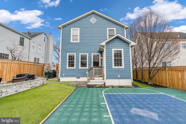 back of house featuring basketball hoop, a fenced backyard, crawl space, a lawn, and a patio area