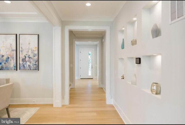 corridor featuring baseboards, visible vents, crown molding, light wood-type flooring, and recessed lighting