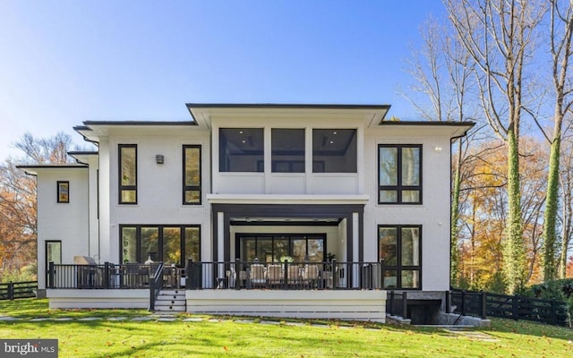 back of house featuring brick siding, fence, and a lawn