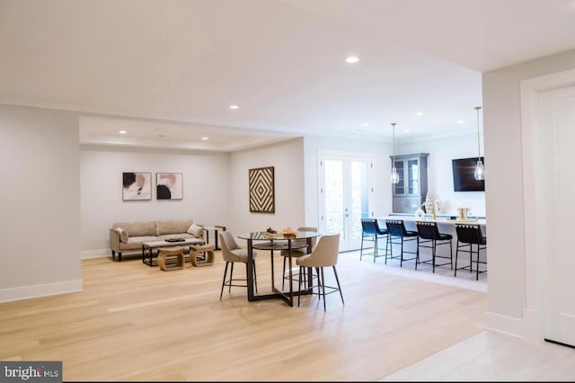 dining space with recessed lighting, french doors, baseboards, and light wood finished floors