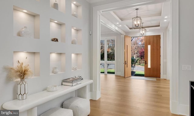 foyer entrance with recessed lighting, light wood-type flooring, a towering ceiling, and an inviting chandelier