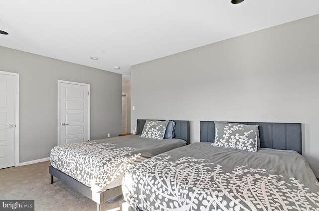 bedroom with baseboards and light colored carpet