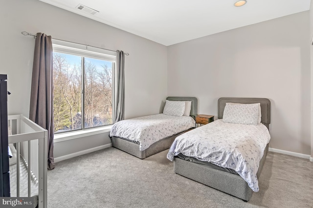 bedroom featuring light carpet, visible vents, and baseboards