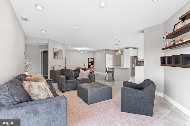 living area with visible vents, baseboards, and recessed lighting