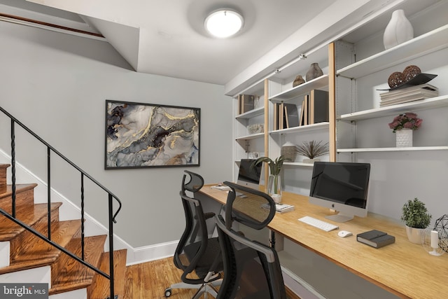 office space with baseboards and wood finished floors