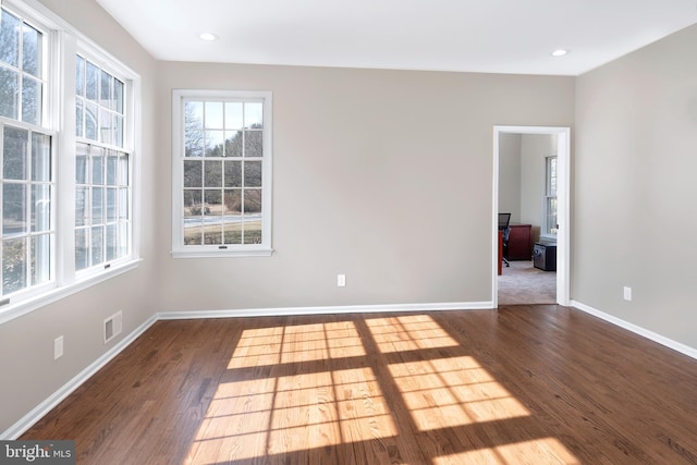 spare room featuring recessed lighting, visible vents, baseboards, and wood finished floors