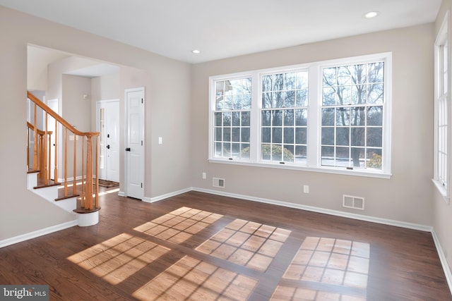 spare room with recessed lighting, visible vents, baseboards, and wood finished floors