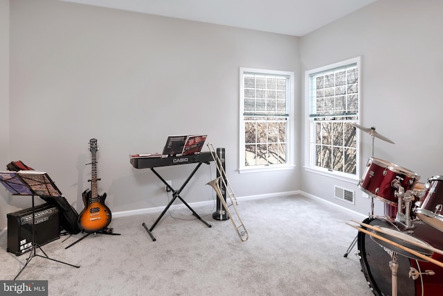 carpeted office with visible vents and baseboards