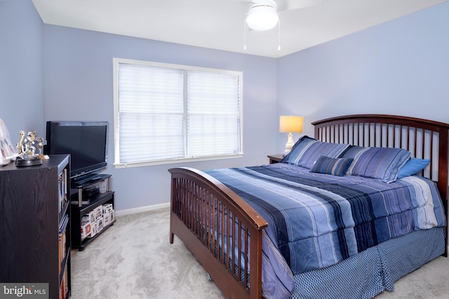 carpeted bedroom with ceiling fan and baseboards