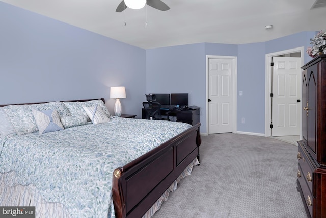 bedroom featuring baseboards, visible vents, a ceiling fan, and light colored carpet