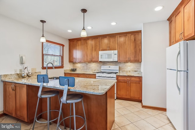 kitchen featuring tasteful backsplash, brown cabinets, white appliances, and a peninsula