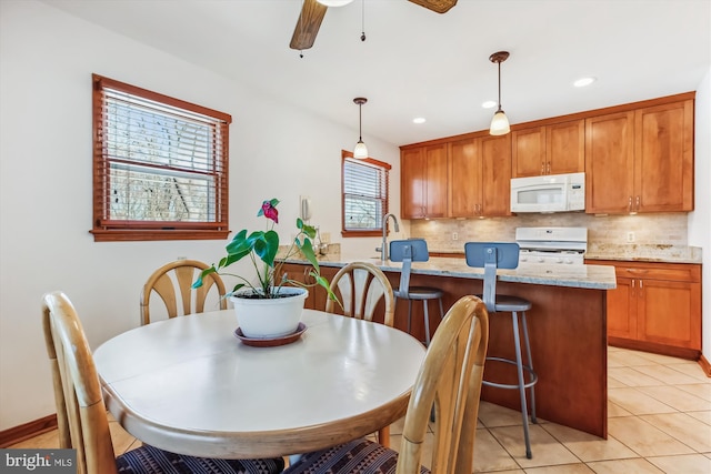 dining area featuring light tile patterned floors, ceiling fan, and recessed lighting