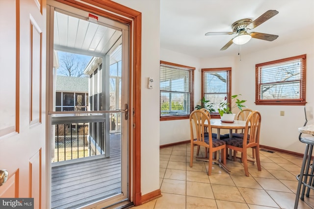 dining space featuring light tile patterned floors, baseboards, visible vents, and ceiling fan