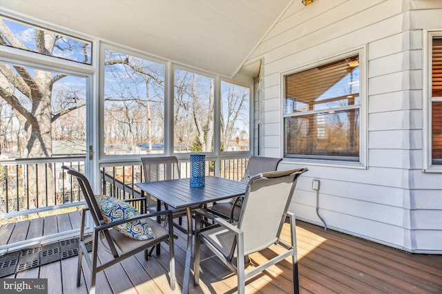 sunroom featuring lofted ceiling