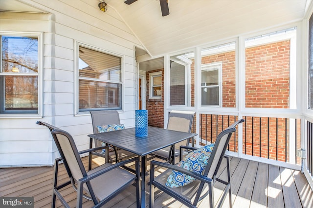 sunroom featuring lofted ceiling and ceiling fan