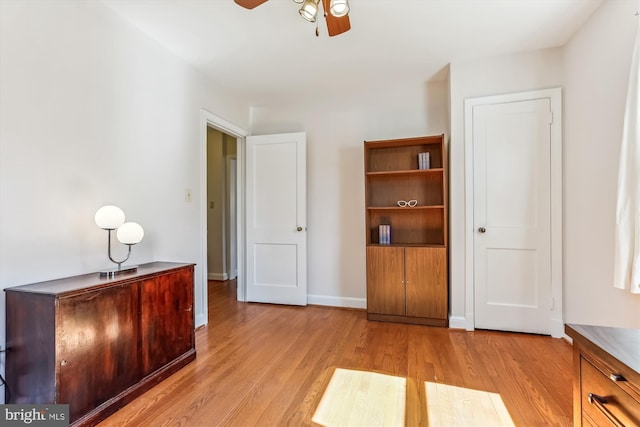 unfurnished bedroom with light wood-style flooring, baseboards, and ceiling fan