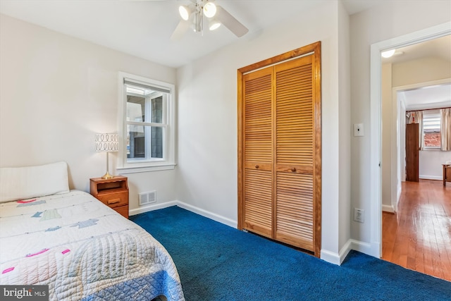 bedroom featuring a closet, visible vents, carpet, and baseboards