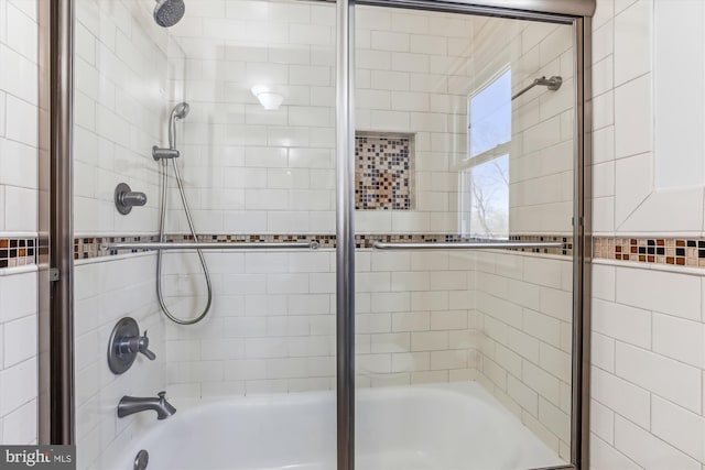 bathroom with shower / bath combination with glass door