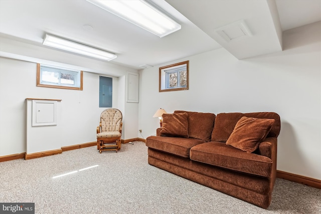 living area with electric panel, carpet, and baseboards