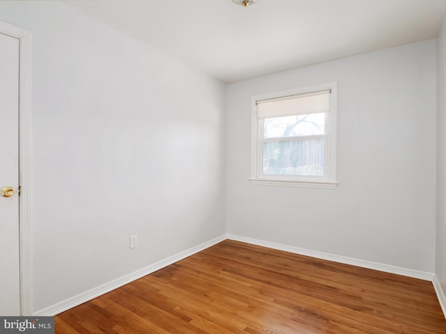 empty room with baseboards and light wood finished floors