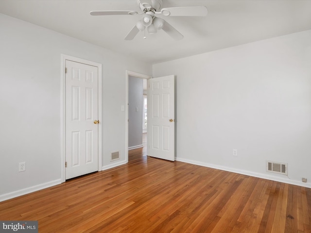 unfurnished bedroom with baseboards, visible vents, and wood finished floors