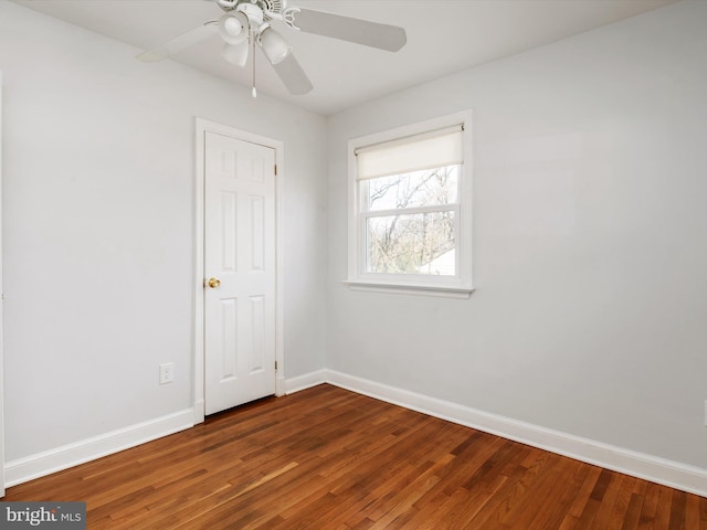 spare room with ceiling fan, baseboards, and wood finished floors