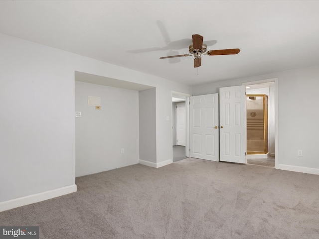 unfurnished bedroom with light carpet, ceiling fan, connected bathroom, and baseboards