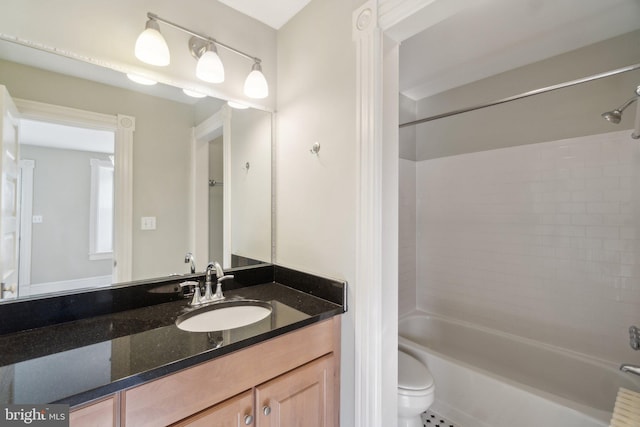 bathroom with bathtub / shower combination, vanity, and toilet