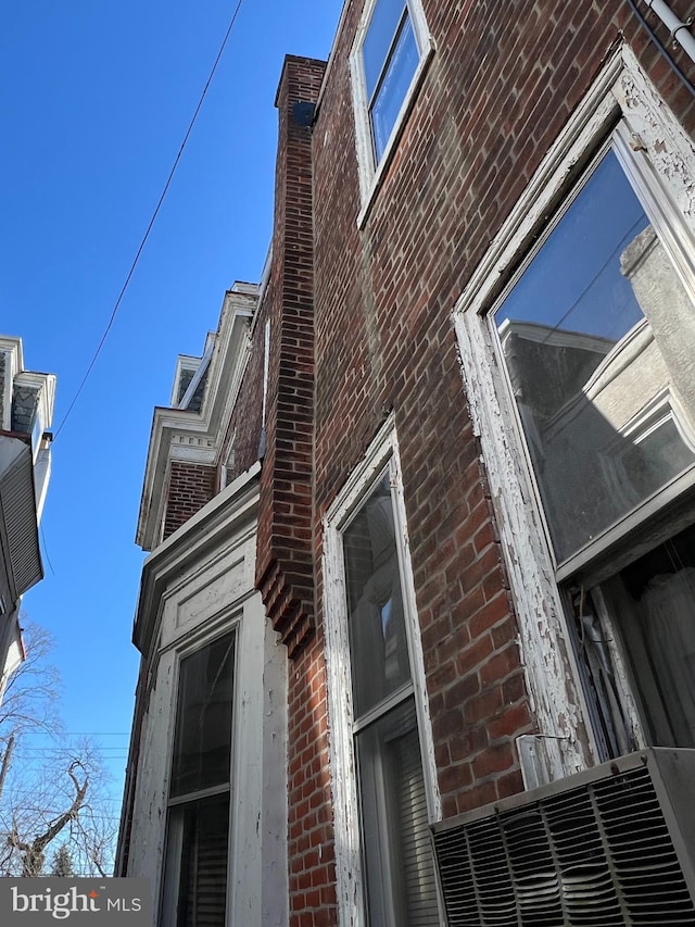 view of side of property featuring brick siding