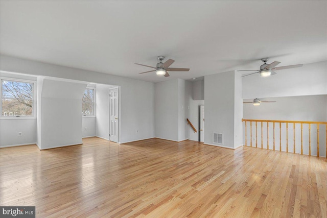 spare room featuring light wood-style flooring and visible vents