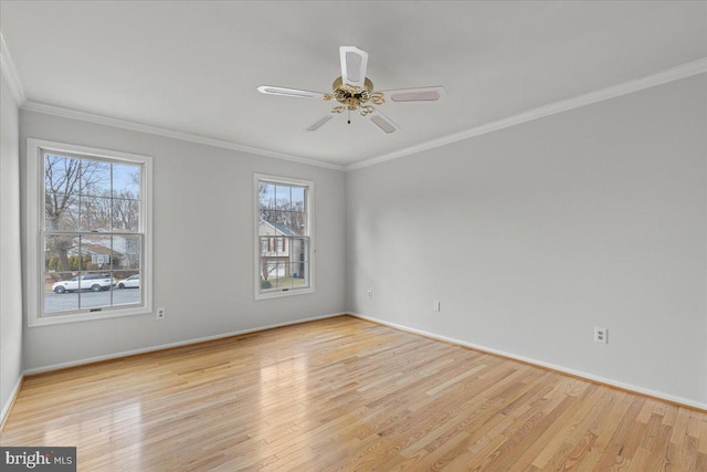 unfurnished room featuring baseboards, light wood-style flooring, a ceiling fan, and crown molding