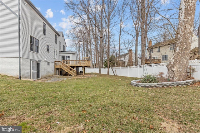 view of yard with fence private yard, stairway, and a wooden deck