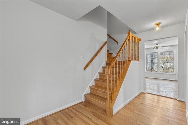 stairs with baseboards and wood finished floors